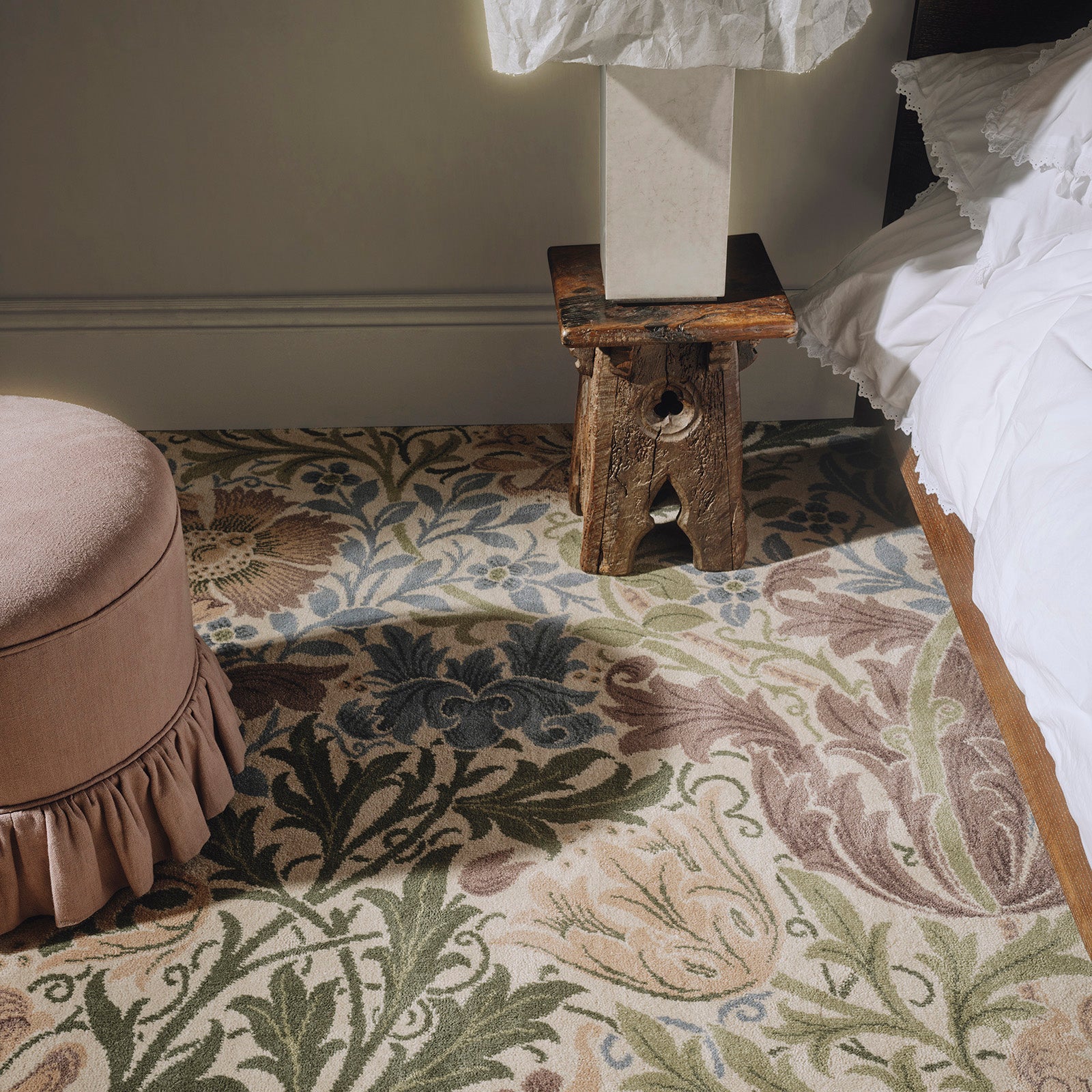 a stool next to a bed