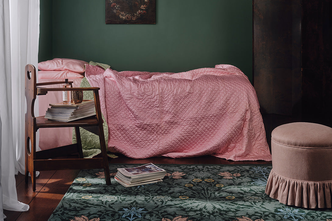 a pink blanket on a bed